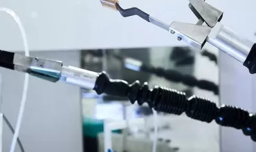 Robotic arm holding test tube.
